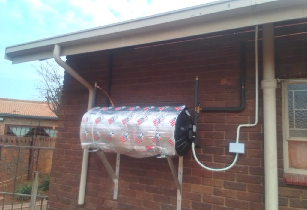 Electric geyser installed on a brick wall