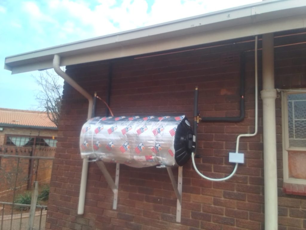 Electric geyser installed on a brick wall